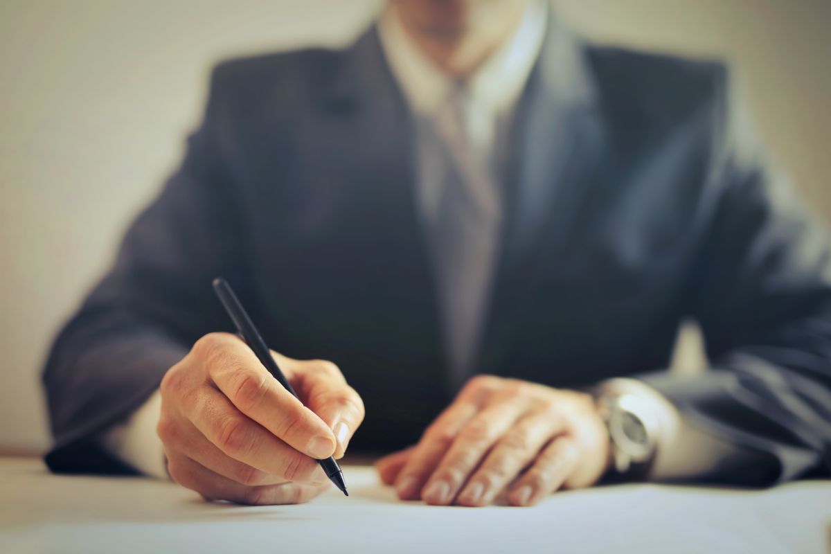 Confident woman with notebook and plan